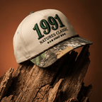 Cap with '1991' and 'Natures Classic' text on a wooden log against a brown background