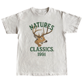 White t-shirt with a deer graphic and 'Natures Classics 1991' text on a green background