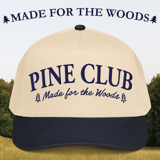 Beige and navy cap with 'Pine Club Made for the Woods' text against a forest background