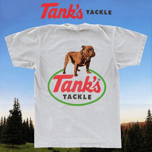 White t-shirt with 'Tank's Tackle' logo and bulldog graphic against a scenic background