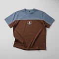 Two-tone blue and brown t-shirt with a logo on a gray background