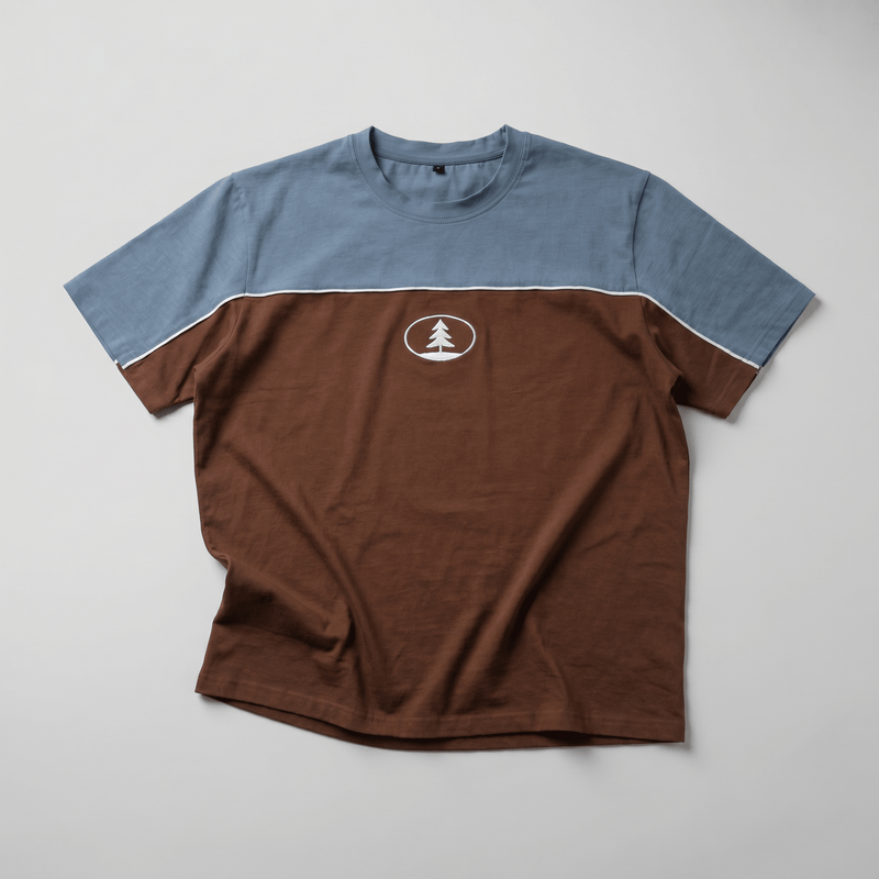 Two-tone blue and brown t-shirt with a logo on a gray background